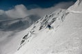 Freeride skier rides down the slope at awesome winter landscape background