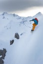 Powder snowboarder in steep terrain