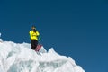 A freerider skier in complete outfit stands on a glacier in the North Caucasus. Skier preparing before jumping from the Royalty Free Stock Photo