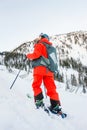 Freerider skier descends from the mountain in the light