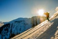 Freerider skier descends from the mountain in the light of the m