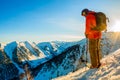 Freerider skier descends from the mountain in the light of the m