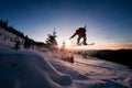 freerider skilfully making jump over snow-covered slope on snowboard against beautiful clear sky. Royalty Free Stock Photo