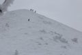 A group of Freerider snowboarders running downhill in steep sunlight slope landscape. Fresh powder snow, freeride, winter sports o Royalty Free Stock Photo