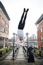 Freerunner Doing a Handstand in the City