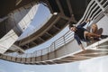 Freerunning athlete is hanging on the bridge and getting ready for a dangerous jump