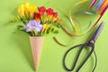 Freesias flowers in ice cream waffles and scissors Royalty Free Stock Photo