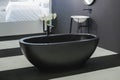 Freestanding black bathtub, stylish minimalist black and white loft style bathroom. Bath, washstand, mirror on the wall