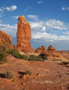 Freestanding red Navajo Sandstone pinnacle in a dry desert environment