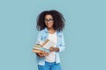 Freestyle. African girl student wearing glasses standing isolated on gray reading books curious Royalty Free Stock Photo