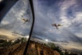 Freestyle biker jumps with motorcycle and reflects in mirror.