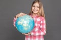 Freestyle. Girl standing on grey with globe smiling cheerful close-up Royalty Free Stock Photo