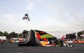 Freestyle motocross rider doing some daring tricks in a high jump with legs Royalty Free Stock Photo