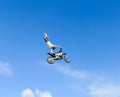 The freestyle Quad bike pilot makes a jump with a high jump with a trick.