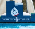 Freestyle skier flying down a practice ramp into a swimming pool at Utah Olympic Park