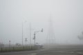 Freeway and intersection with traffic lights in dense fog