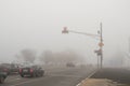 Freeway and intersection with traffic lights in dense fog