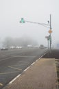 Freeway and intersection with traffic lights in dense fog