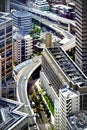 a freeway passes through several tall buildings in the city of tokyo Royalty Free Stock Photo