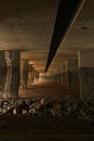 Freeway underpass is dark and foreboding. Royalty Free Stock Photo