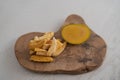 Freeze-dried mango with fresh one on olive wood board with copy space Royalty Free Stock Photo