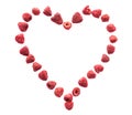 Freeze dried raspberries on a white background in the form of heart. Lyophilization. Food for astronauts.