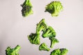 Freeze Dropping Green Brocolli on White Background