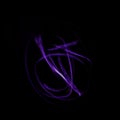 Freeze light photo, abstract streaks purple color on black background, made with light painting or light drawing