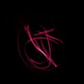 Freeze light photo, abstract streaks red color on black background, made with light painting or light drawing