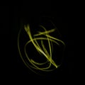 Freeze light photo, abstract streaks yellow color on black background, made with light painting or light drawing