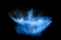 Freeze motion of blue dust explosion on black background. Royalty Free Stock Photo