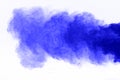 Freeze motion of blue dust explosion isolated. Blue powder explosion on white background. Royalty Free Stock Photo