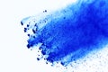 Freeze motion of blue powder explosions isolated on white background. Abstract blue powder splashed on white background.
