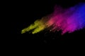 Freeze motion of colored powder explosion isolated on black background. Abstract of Multicolor dust splatted. Royalty Free Stock Photo