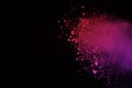 Freeze motion of colored powder explosion isolated on black background. Abstract of Multicolor dust splatted. Royalty Free Stock Photo