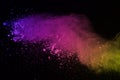 Freeze motion of colored powder explosion isolated on black background. Abstract of Multicolor dust splatted. Royalty Free Stock Photo