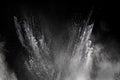 Freeze motion explosion of white dust on a black background. Royalty Free Stock Photo