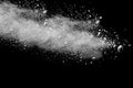 Freeze motion explosion of white dust on a black background. Royalty Free Stock Photo