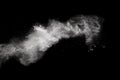 Freeze motion explosion of white dust on a black background. Royalty Free Stock Photo