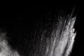 Freeze motion explosion of white dust on a black background. Royalty Free Stock Photo