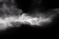 Freeze motion explosion of white powder on a black background.Stopping the movement of white dust on dark background Royalty Free Stock Photo