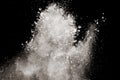 Freeze motion explosion of white powder on a black background.Stopping the movement of white dust on dark background Royalty Free Stock Photo