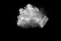 Freeze motion of white dust particles splash on black background.White powder explosion clouds Royalty Free Stock Photo