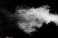 Freeze motion of white dust particles splash on black background.White powder explosion clouds Royalty Free Stock Photo