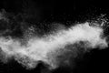 Freeze motion of white dust particles splash on black background.White powder explosion clouds Royalty Free Stock Photo