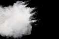 Freeze motion of white dust particles splash on black background.White powder explosion clouds Royalty Free Stock Photo