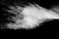 Freeze motion of white dust particles splash on black background.White powder explosion clouds Royalty Free Stock Photo