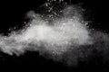 Freeze motion of white dust particles splash on black background.White powder explosion clouds Royalty Free Stock Photo