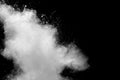 Freeze motion of white dust particles splash on black background.White powder explosion clouds Royalty Free Stock Photo