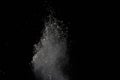 Freeze motion of white powder explosion on black background. Stop motion of white dust on dark background. Explosive white cloud Royalty Free Stock Photo